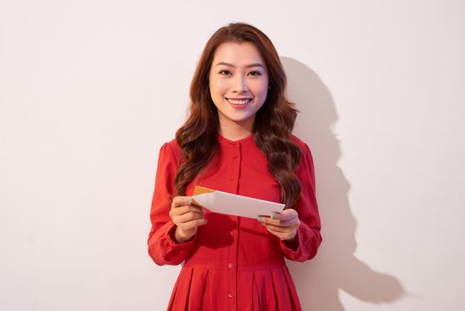 Lovely female with red heart isolated on gray background, celebration of Valentine day, romantic feelings, harmony and love concept