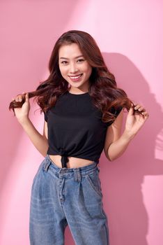 lifestyle, beauty and people concept: Young cute smiling girl over pink background