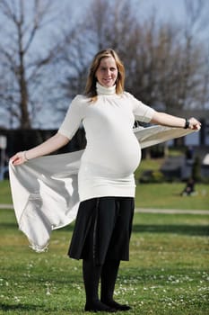 happy young pregnant womant have fun outdoor in nature at sunny day