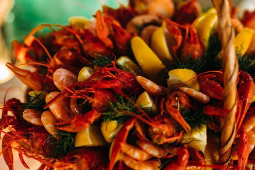 Macro stock photo of a boiled crayfish or clawfish in artificial light. Prepared lobster in close-up.