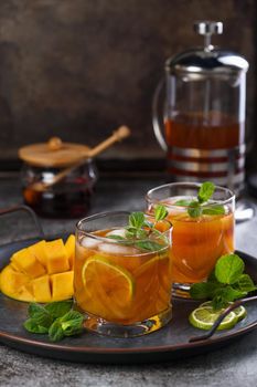 Mango iced tea with lime and mint. Refreshing organic soft drink