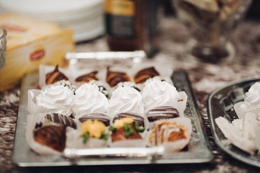 picture of a lot of different cakes, cupcakes and other sweets on a big plate