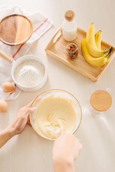 fresh eggs milk and flour on white table