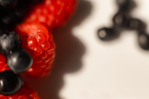 picture of juicy fresh ripe red strawberry berries in a white ceramic plate on the table under bright sunlight