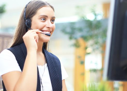 Woman customer support operator with headset and smiling