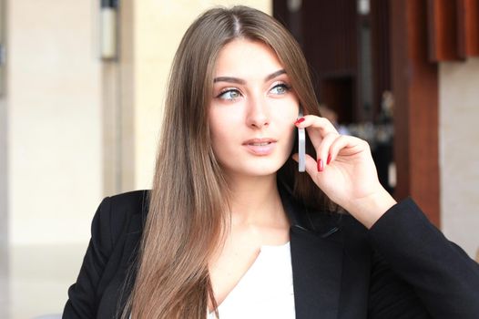 businesswoman sitting sofa using smartphone in coffee shop.