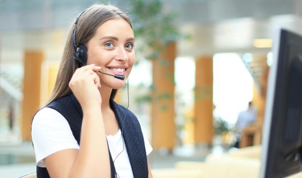 Woman customer support operator with headset and smiling