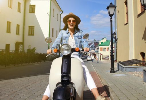 Portrait smilling beautiful girl sitting on retro scooter.