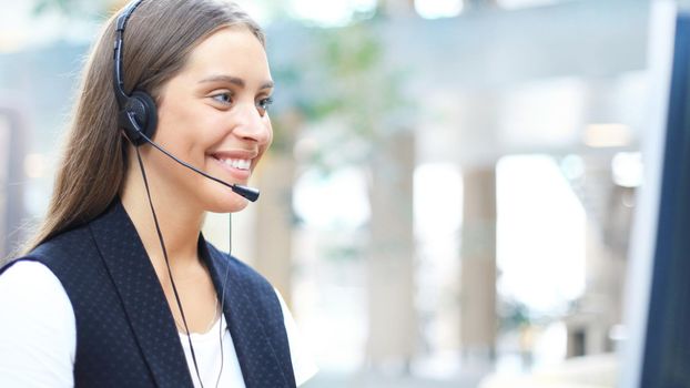 Woman customer support operator with headset and smiling