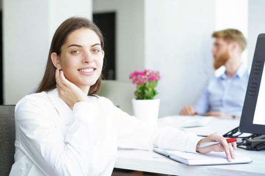 business woman with her staff, people group in background at modern bright office indoors.