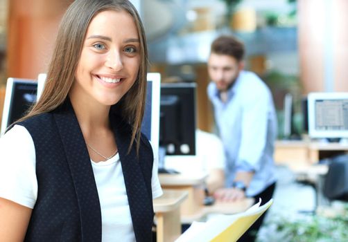 business woman with her staff, people group in background at modern bright office indoors