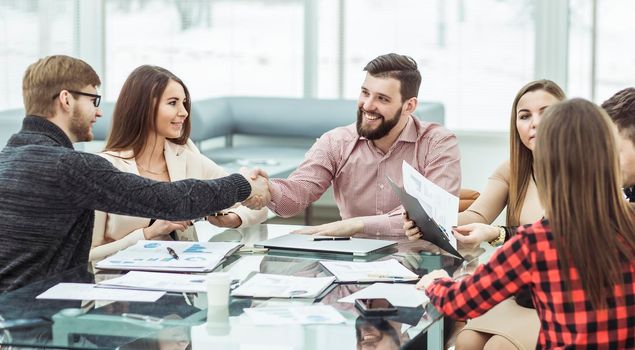 handshake financial partners after the discussion of a new contract in the workplace in the office