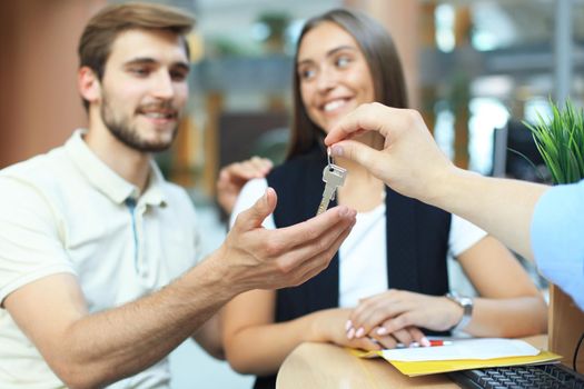 Successful lawyer giving consultation to family couple about buying house.