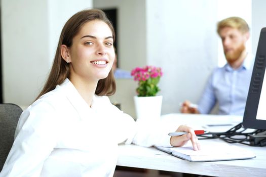 business woman with her staff, people group in background at modern bright office indoors.