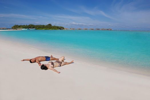 happy young asian couple enjoying summer and have on beautiful white sand beach