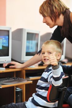 it education with children group  in school at computer science class learning leassons and practice typing 