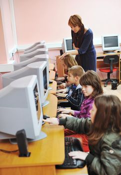 it education with children group  in school at computer science class learning leassons and practice typing 