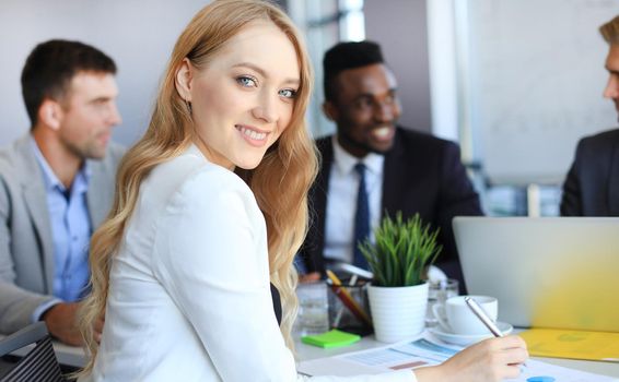business woman with her staff, people group in background at modern bright office indoors