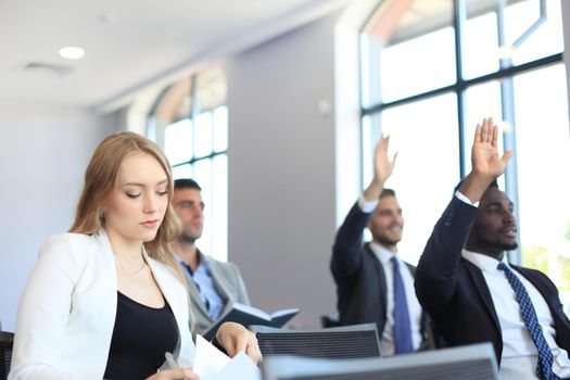 Group of businessmen sitting in conference to speech while having business meeting.