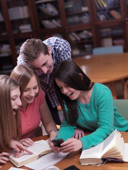 happy young teens group in school on chemisty lessons and library education