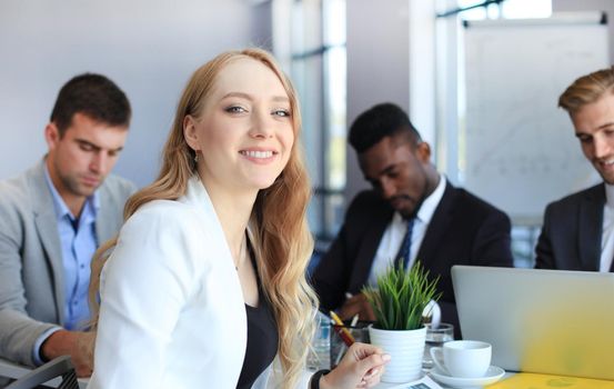 business woman with her staff, people group in background at modern bright office indoors