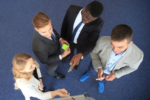Business people team at presentation working with charts and diargams at flipchart. Top view.