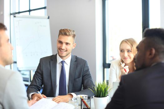 Businessman with colleagues in the background in office