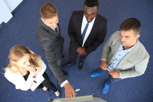 Business people team at presentation working with charts and diargams at flipchart. Top view.
