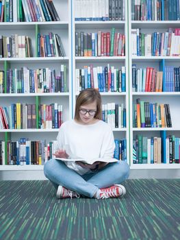student girl  in collage school library reading book