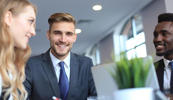Businessman with colleagues in the background in office