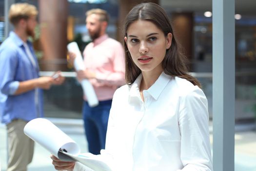 business woman with her staff, people group in background at modern bright office indoors