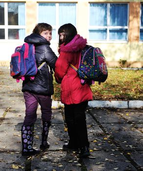 happy school girls running outdoor at sunny autumn day 