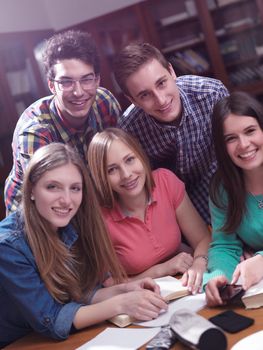 happy young teens group in school on chemisty lessons and library education