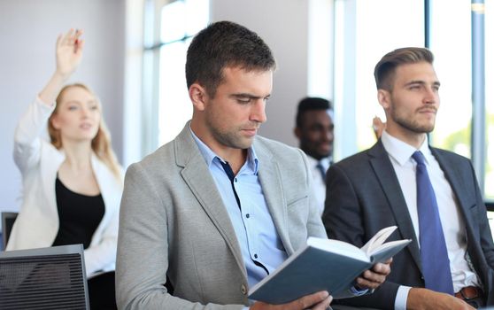 Group of businessmen sitting in conference to speech while having business meeting.