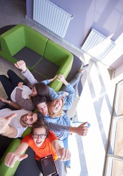 students group working on school  project  together on tablet computer  at modern university