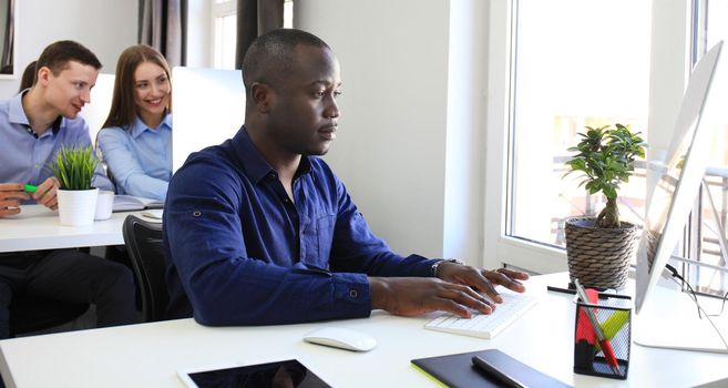 Handsome Afro American businessman working in office