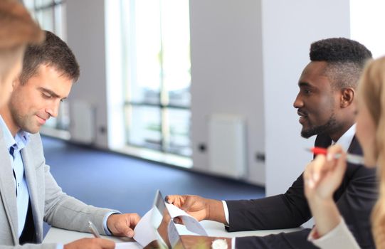Businessman smiling happily as his business partner finally signing important contract.