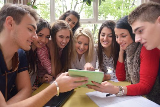 happy young teens group in school on chemisty lessons and library education