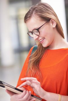 happy student girl working on tablet computer at modern school university indoors