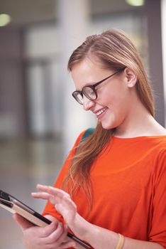 happy student girl working on tablet computer at modern school university indoors