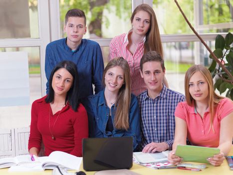 happy young teens group in school on chemisty lessons and library education