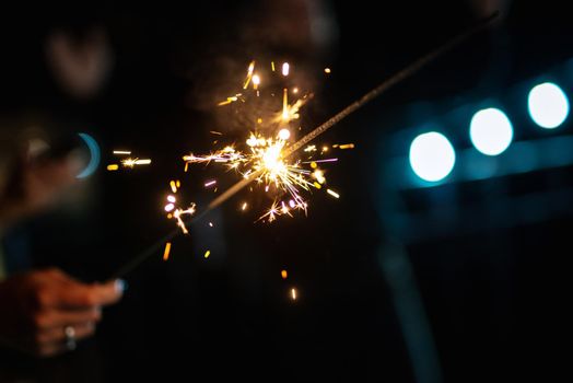 sparklers at the wedding, a couple of newlyweds on the background