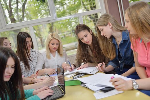 happy young teens group in school on chemisty lessons and library education