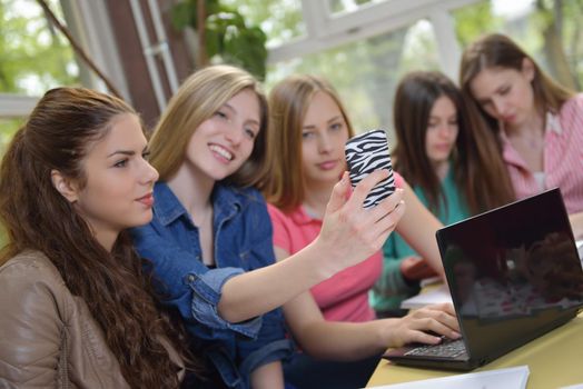 happy young teens group in school on chemisty lessons and library education