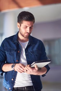 student using tablet computer for education in school, university interior in background