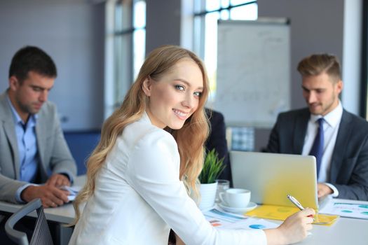 business woman with her staff, people group in background at modern bright office indoors