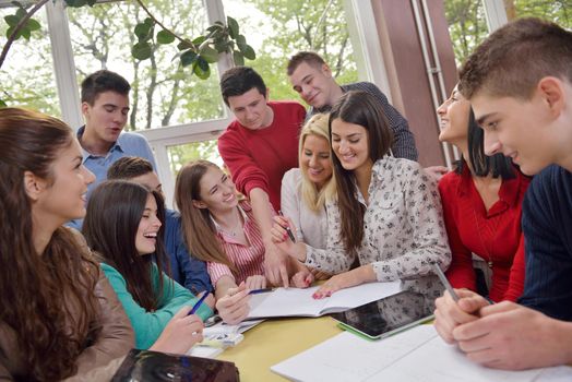 happy young teens group in school on chemisty lessons and library education