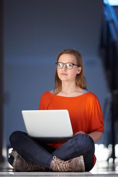 happy student girl working on laptop computer at modern school university indoors