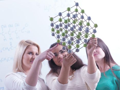 happy young teens group in school on chemisty lessons and library education