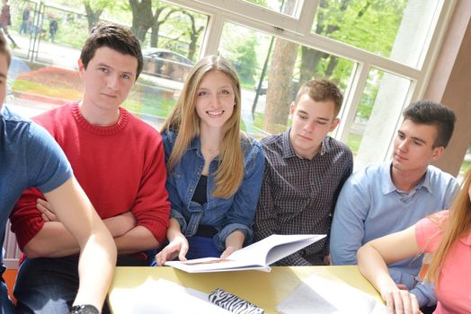 happy young teens group in school on chemisty lessons and library education